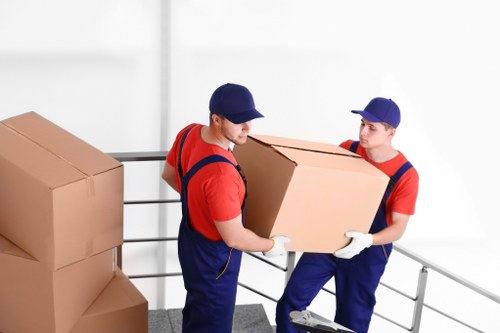 Removal team handling furniture and boxes during a Rainham house move